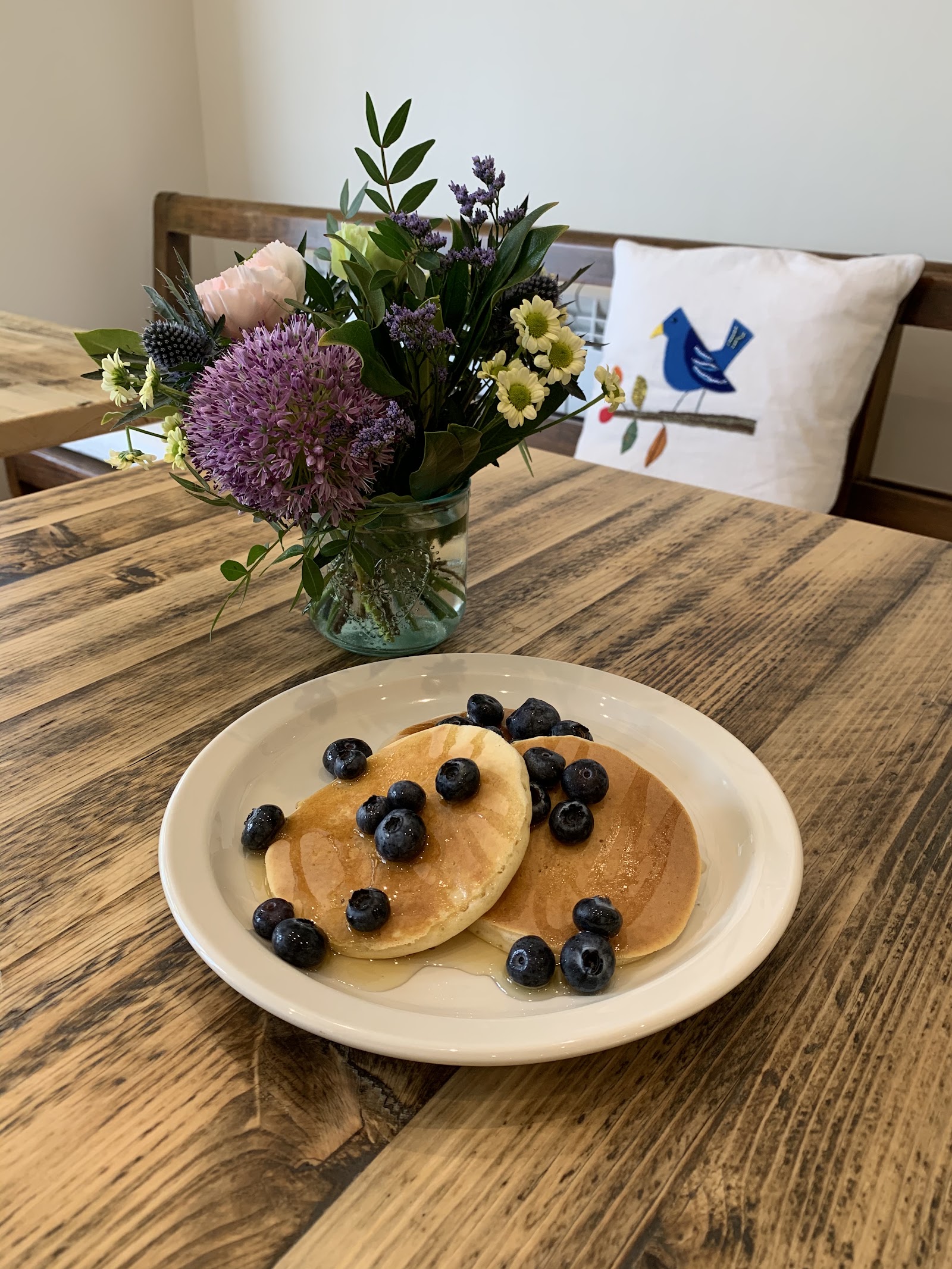 Blueberry pancakes with syrup on a rustic wooden table at The Coffee Tree