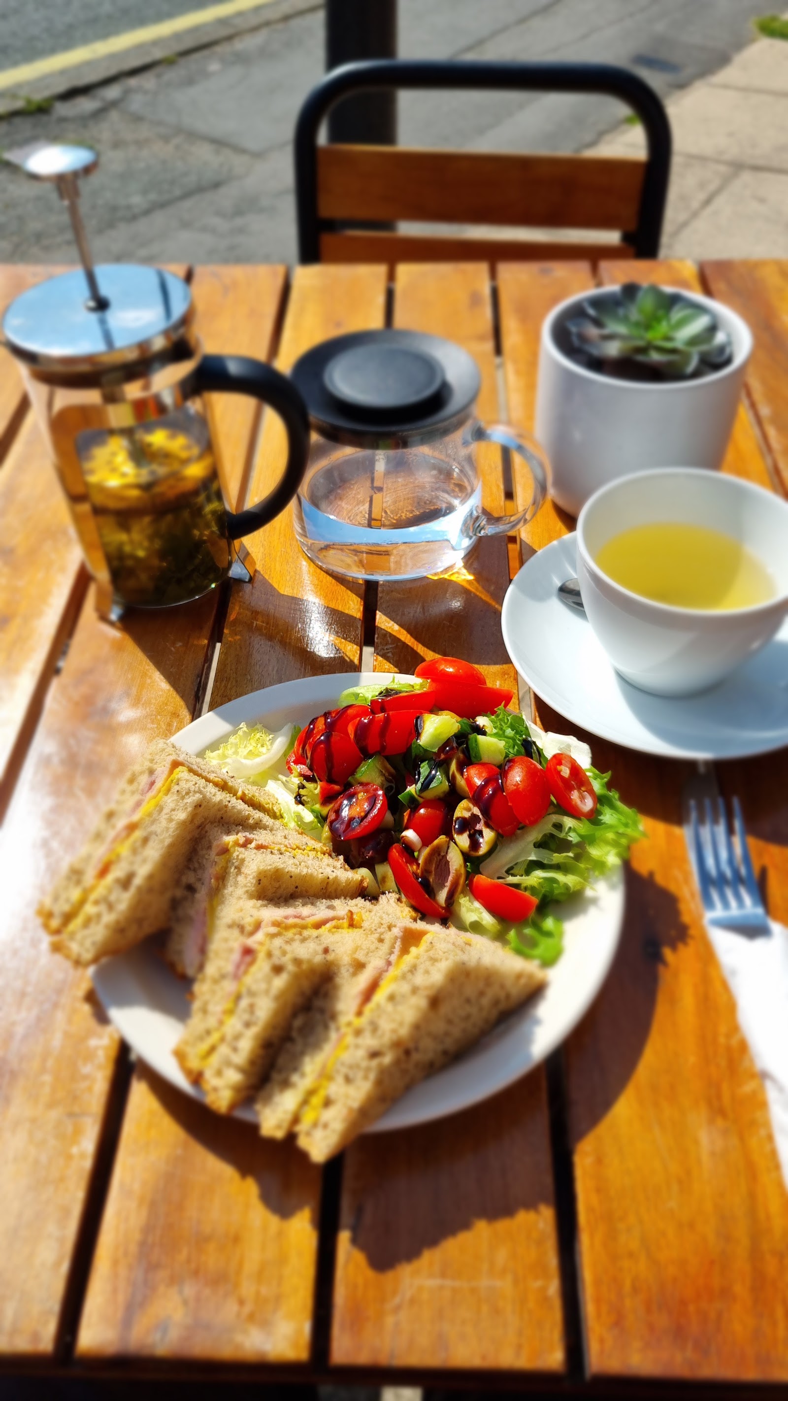 Sandwich quarters with side salad and a pot of tea in The Coffee Tree garden